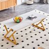 A coffee table made of rock slab material, with a smooth and natural surface that complements the modern design of the golden metal legs