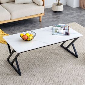 A coffee table made of rock slab material, with a smooth and natural surface that complements the modern design of the black metal legs